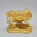 Direct rear back view of the solid brass Kamadhenu cow murti highlighting the polished glossy gold layered finish along the rear blanket.
