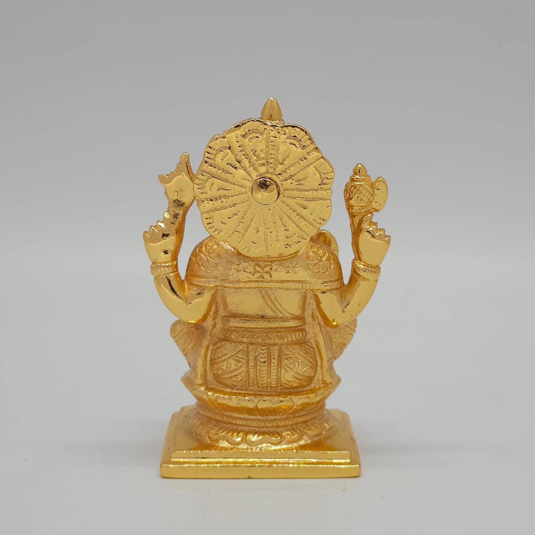 Vamamukhi Vigneshwara Gold Idol Back View Sunburst Halo Rectangular Pedestal Base
